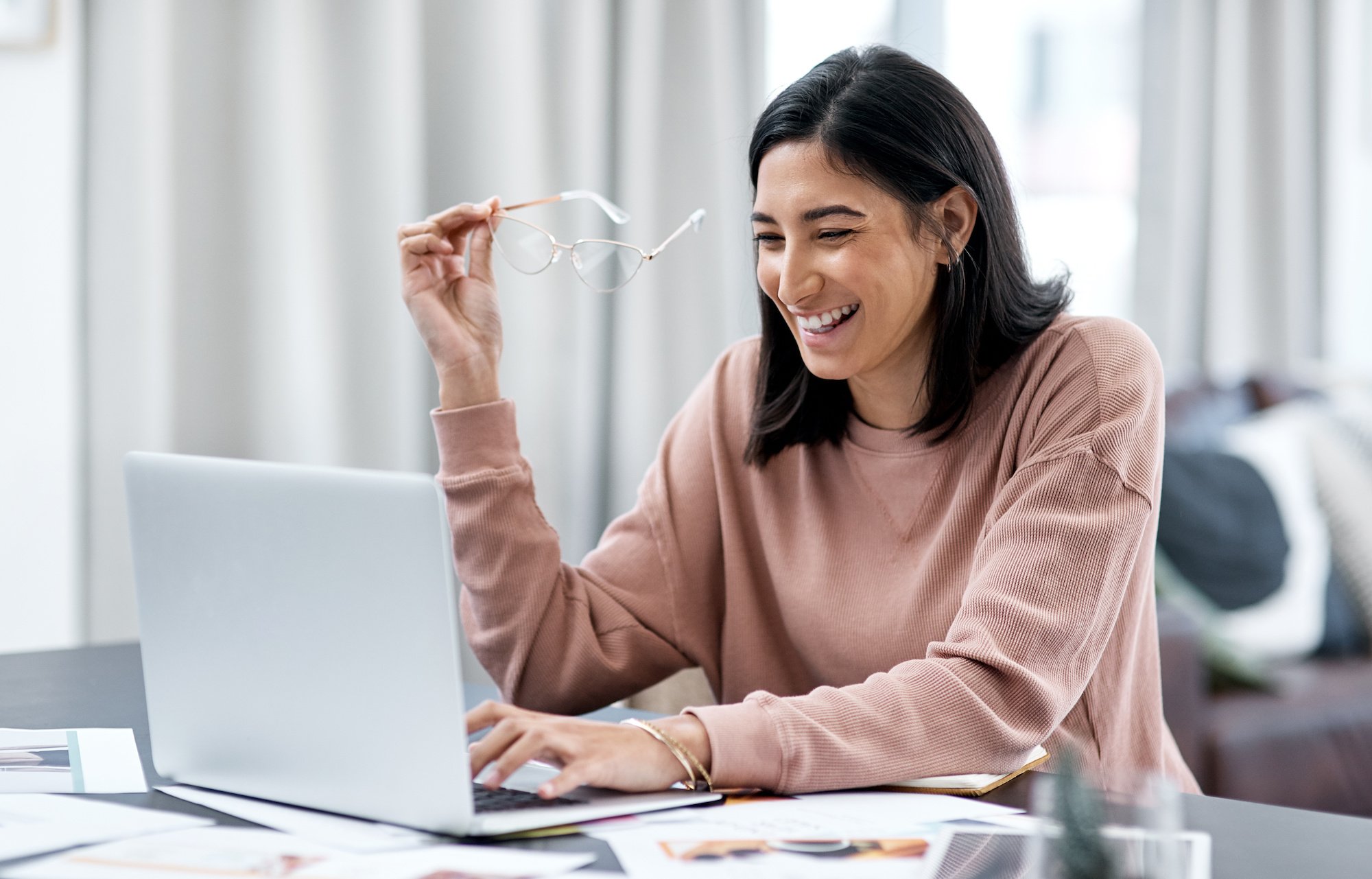 A female working on her laptop while asking her boss for new technology to benefit the company