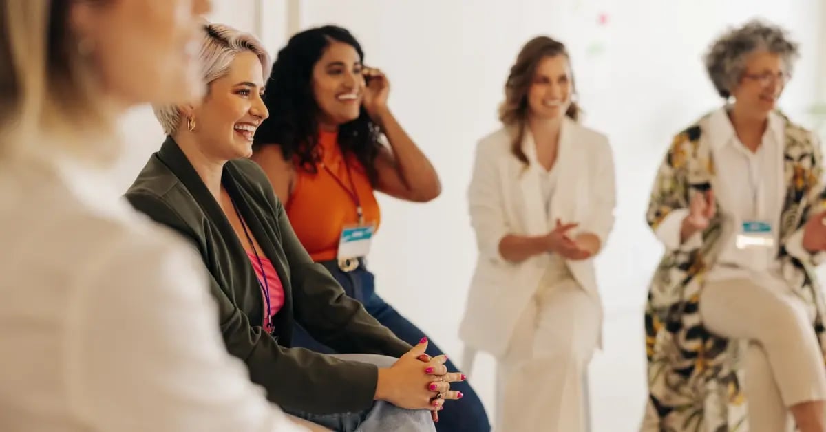 Female attendees in a roundtable discussion at an event