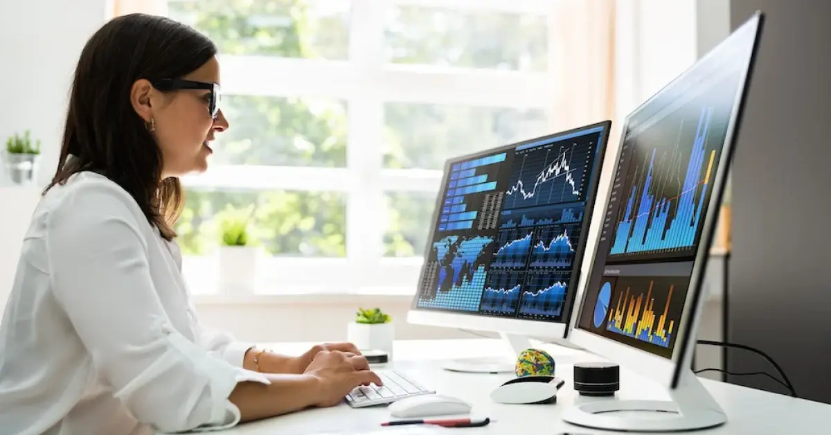Data-Driven Executive Assistant reading graphics on her desktop in the office
