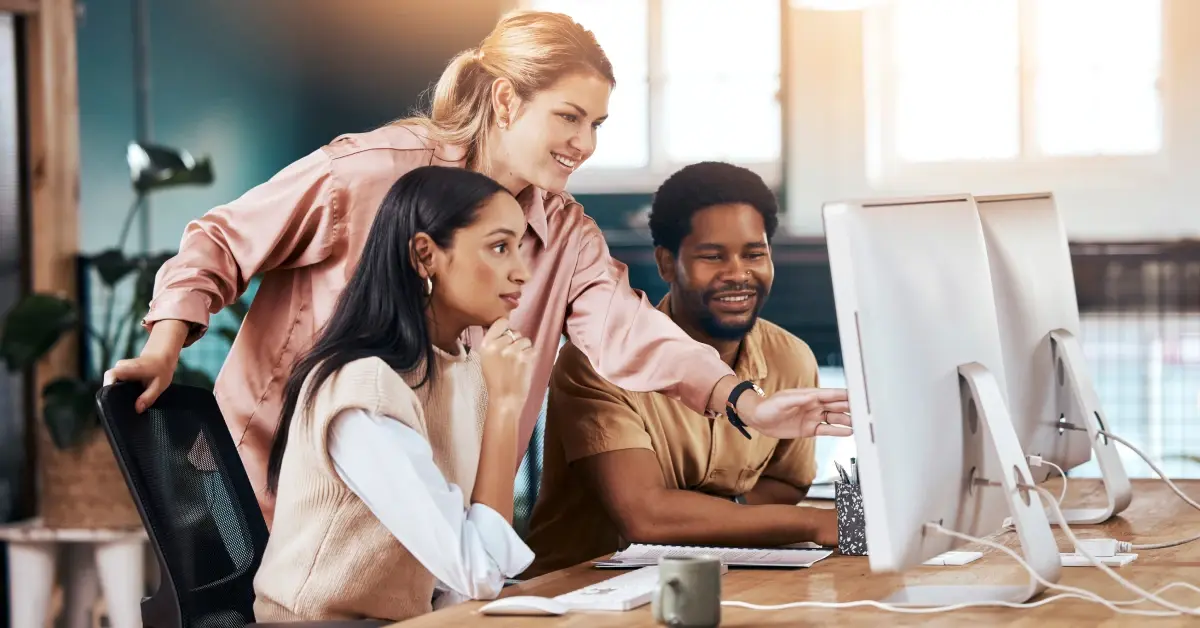 Executive Assistants pulling post-meeting actions on the computer in the office